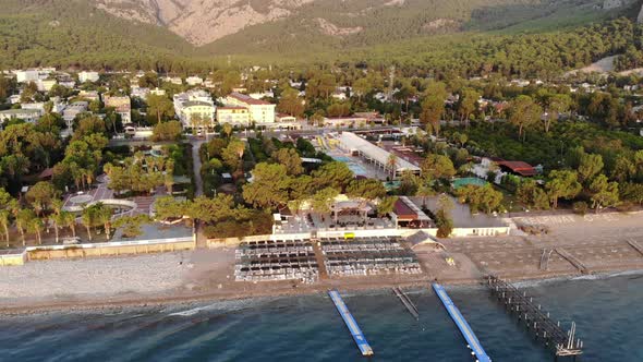 Aerial View of the Rows of Sun Loungers on the Sea Beach and a Large Hotel with Many Pools on the