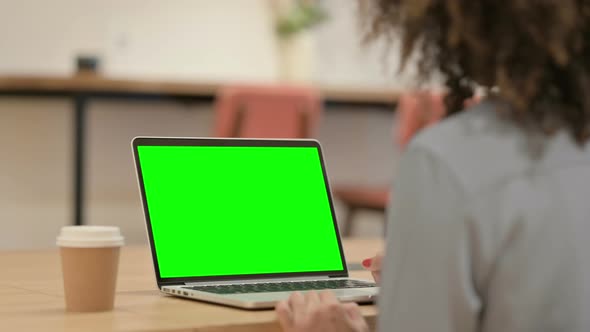 African Woman Using Laptop with Green Chroma Key Screen