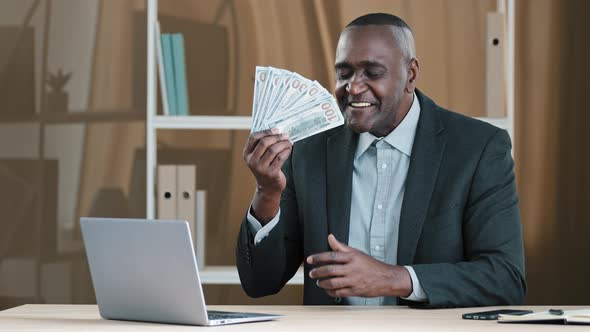 Old Mature African Businessman 60s Worker Banker Banking Agent Senior Man Sitting in Office Rejoices