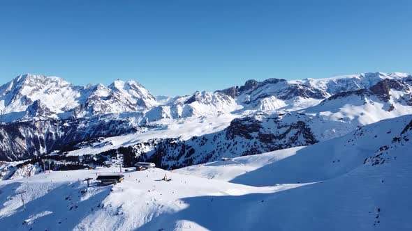 Aerial View of the Alps Mountains in France. Mountain Tops Covered in Snow. Alpine Ski Facilities