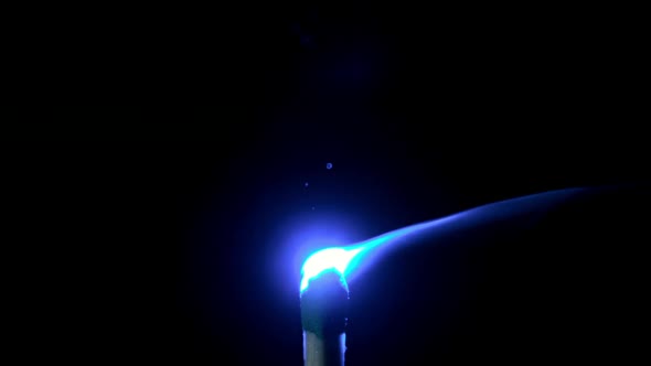 Slow motion of match lighting from blue laser pointer