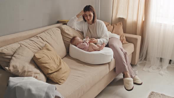 Mom Watching Baby Eat from Bottle