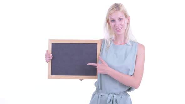 Happy Young Blonde Woman Holding Blackboard and Giving Thumbs Up