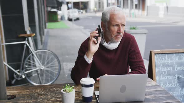 Caucasian man out and about in a coffee wearing a face mask against coronavirus