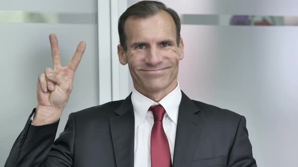 Victory Sign by Businessman