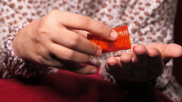 Close Up of Women Hand Taking Pills