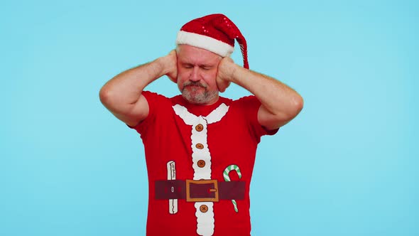 Man in Christmas Tshirt Covering Ears and Gesturing No Avoiding Advice Ignoring Unpleasant Noise