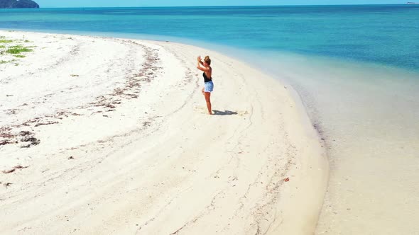 Beautiful ladies enjoying life on idyllic tourist beach trip by blue lagoon and white sand backgroun