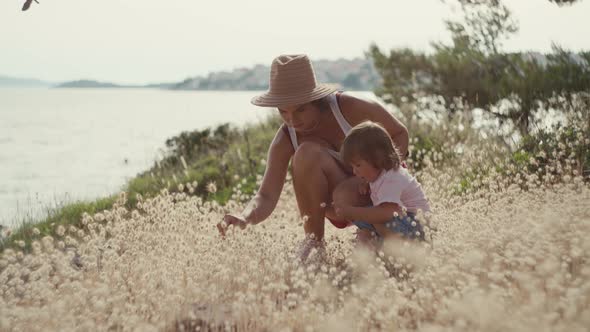 Mom Plays with Her Daughter By the Ocean