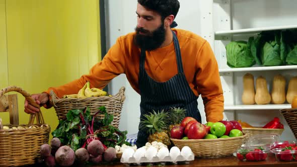 Male staff working at vegetable counter