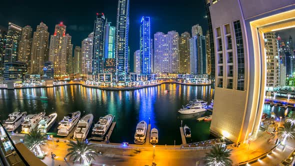 View of Dubai Marina Towers and Yachts in Canal in Dubai Night Timelapse