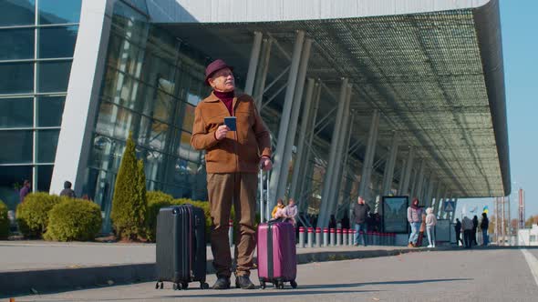 Portrait of Senior Pensioner Tourist Grandfather Stay Near Airport Hall Waiting for Plane Travel