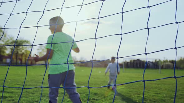 Kids Playing Soccer on the Grass