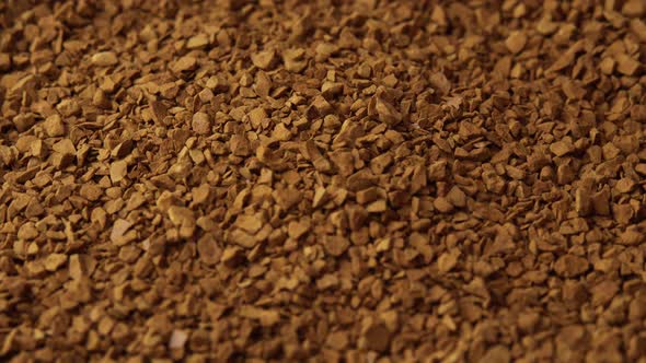 Granules of Instant Coffee Sprinkled on a Plate Closeup Spinning As a Backdground for a Coffee Shop