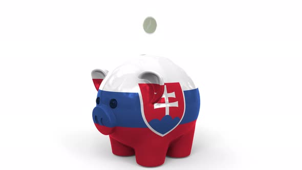 Coins Fall Into Piggy Bank Painted with Flag of Slovakia alt