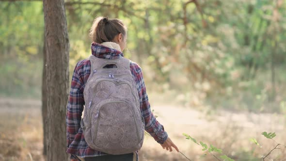 Casual Style Woman in Autumn Woods with Backpack