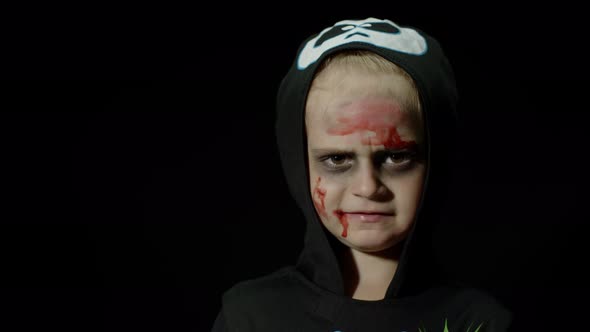 Halloween, Angry Girl with Blood Makeup on Face. Kid Dressed As Scary Skeleton, Posing, Making Faces