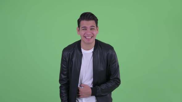 Happy Young Handsome Multi Ethnic Man Laughing and Pointing at Camera