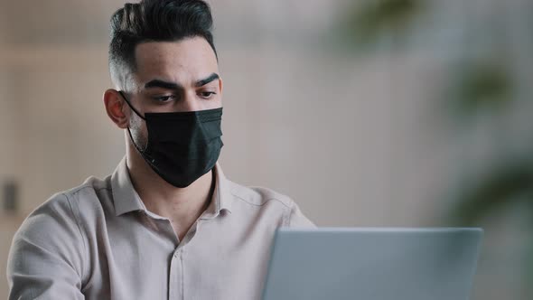 Arabian Sick Businessman in Medical Mask Designer Programmer Typing on Laptop Search Information in