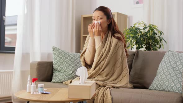 Sick Woman Blowing Nose in Paper Tissue at Home
