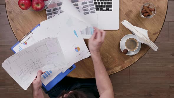 Top View of a Man During a Coffee Break Doing Some Work