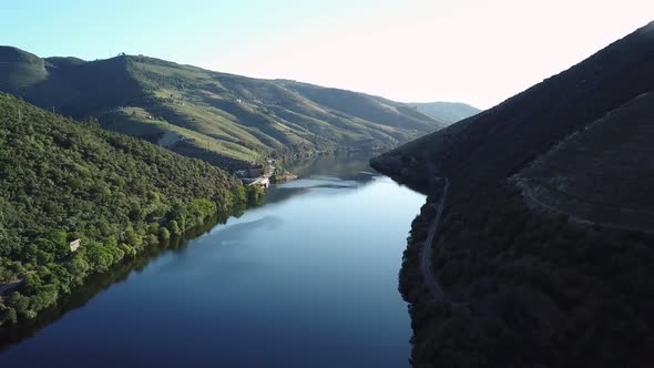 Reversing along the peaceful Douro River to reveal beautiful early morning view of Douro Valley.