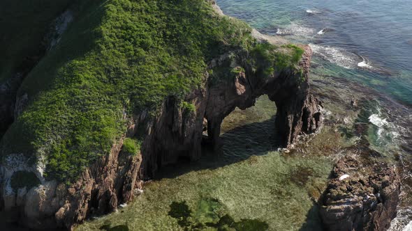 Drone View of a Natural Stone Arch By the Sea