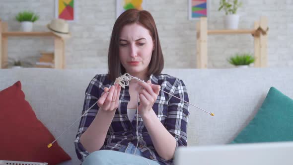 Clumsy Young Woman Engaged in Knitting Slow Mo