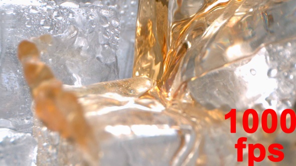 Alcohol Liquor Drink Is Pouring Onto Ice In A Glass In High Speed