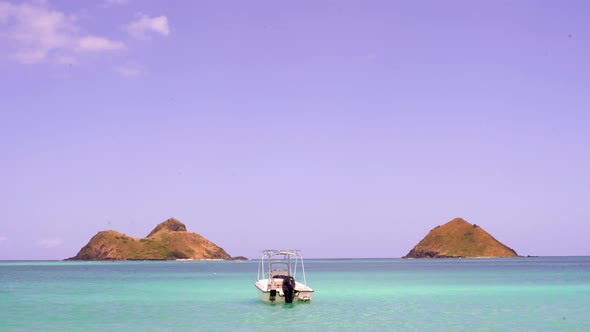 Boat floats in the tropical blue water of Oahu, Hawaii