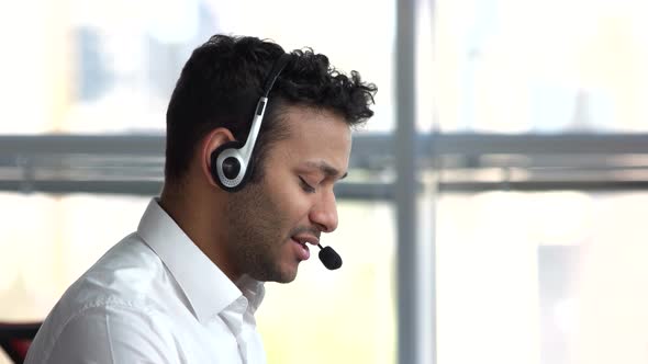 Close Up European Man Face with Headset Working in Office.