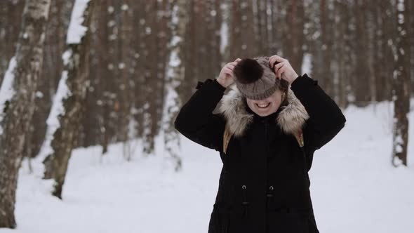 Portrait Caucasian Woman in Winter Parkshe Puts Hat on the Camera