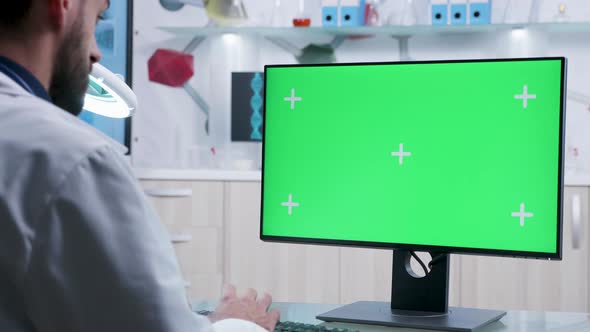 Researcher Working on Green Screen Mock-up PC in Modern Laboratory