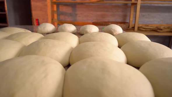 Close-up of finished pink dough in bakery on wooden table.