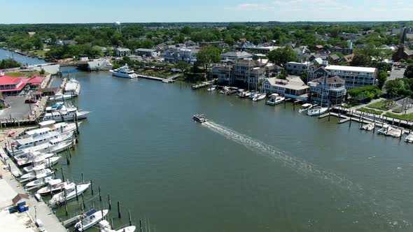 AERIAL SLOW MOTION Small Boat Cruising Down Lewes Canal, Delaware