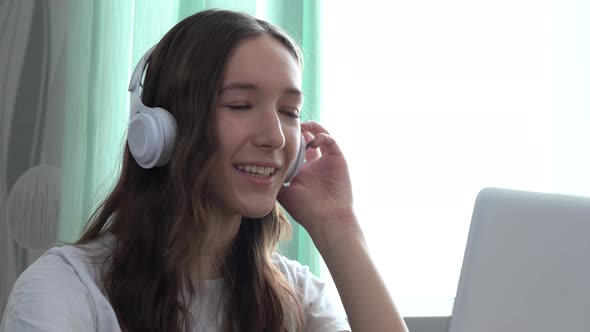 The Happy Girl Communicates Remotely Through the Internet