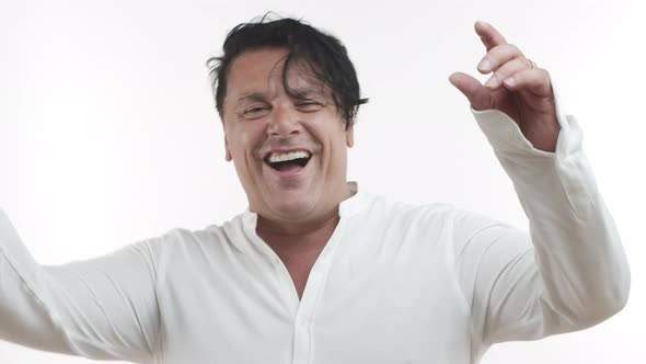 Closeup of Chubby Middleaged Man in Casual White Tshirt Smiling and Laughing Having Fun Looking