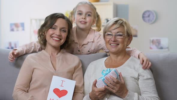 Mom and Granny Holding Presents From Little Girl, Posing on Camera, Mother Day