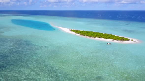 Aerial panorama of exotic resort beach wildlife by blue lagoon with sand background