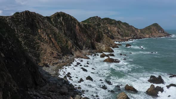 Aerial view of the waves crash against the rocks in Eo Gio beach, Nhon Ly