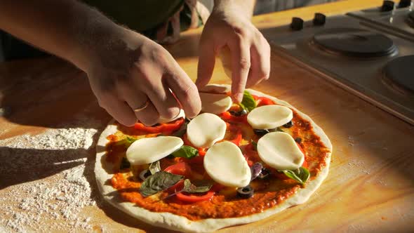Mozzarella Pizza Dressing Male Baker at Kitchen Tops Pie with Cheese Slices