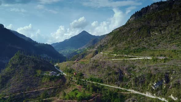 Winding Road in the Mountain with Felled Trees