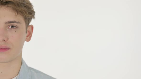 Half Face of Serious Young Man on White Background