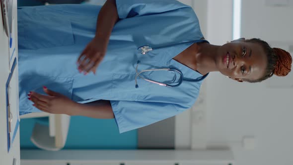 Vertical Video Portrait of Medical Assistant Wearing Uniform Standing in Cabinet