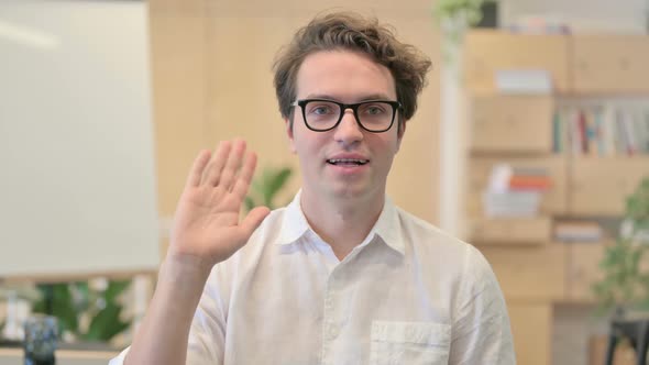 Portrait of Young Man Waving Welcoming