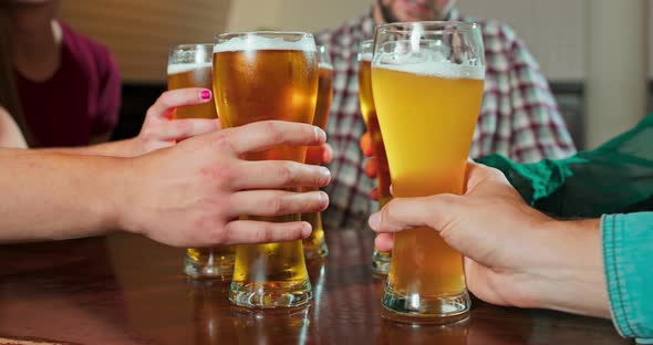 Group of Friends Enjoying a Beer at Pub in Poland Close Up and Focus on