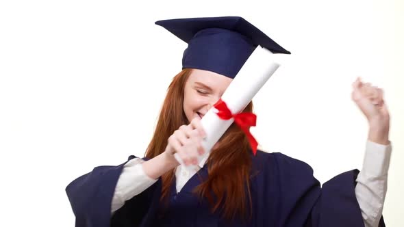 Young Happy Redhead Cacasian Graduate Girl Happily Showing Her Diploma on White Background Wearing