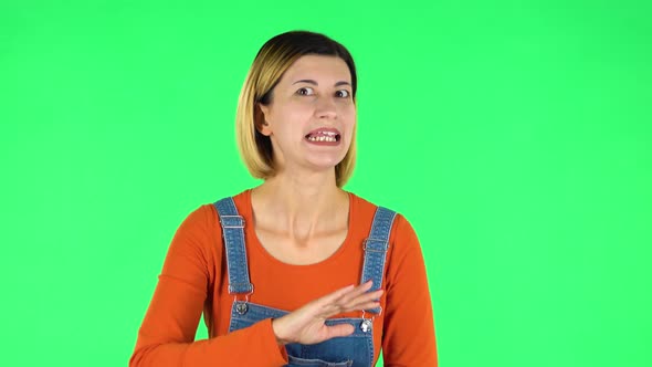 Unhappy Girl Showing Thumbs Down Gesture. Green Screen