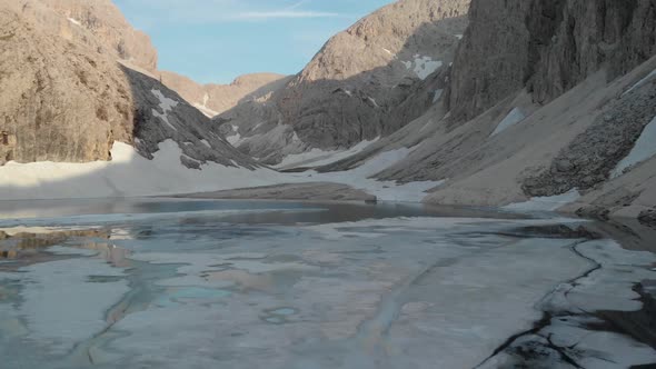 Drone Flying Over Water Surface of Alpine Lake Antermoia in Dolomites Italy