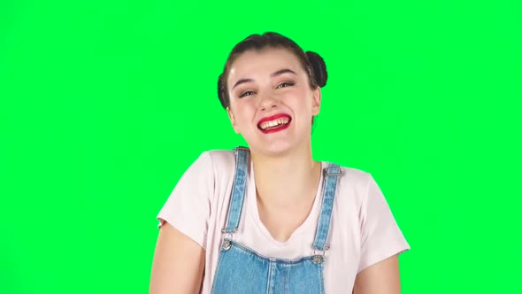 Portrait of Cheery Female Bursting with Laughter Being in Positive Over Green Screen. Slow Motion